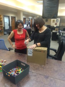 Sherri and Karen carefully open the package...